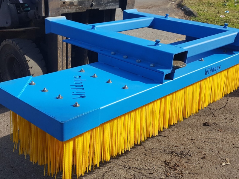 Blue and yellow widdops forklift sweeper attachment